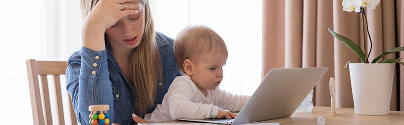 tired working mom with child in her lap feeling exhausted