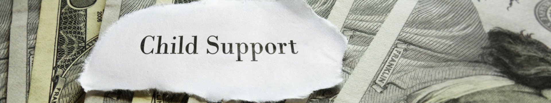 Child support written on a piece of paper sitting on top of money