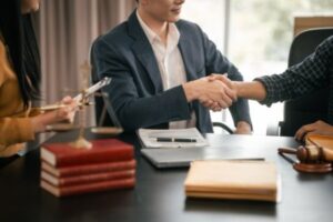 Lawyer shaking hands with a client after mediation