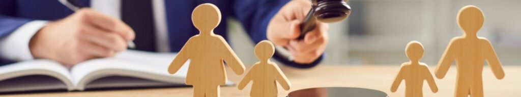 Wooden family figures with judge and gavel.