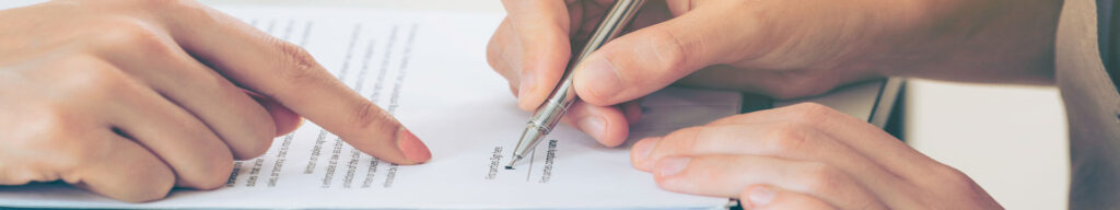 A lawyer assisting a client in signing documents