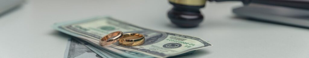 spousal support in Florida being placed on table with wedding rings and gavel in background