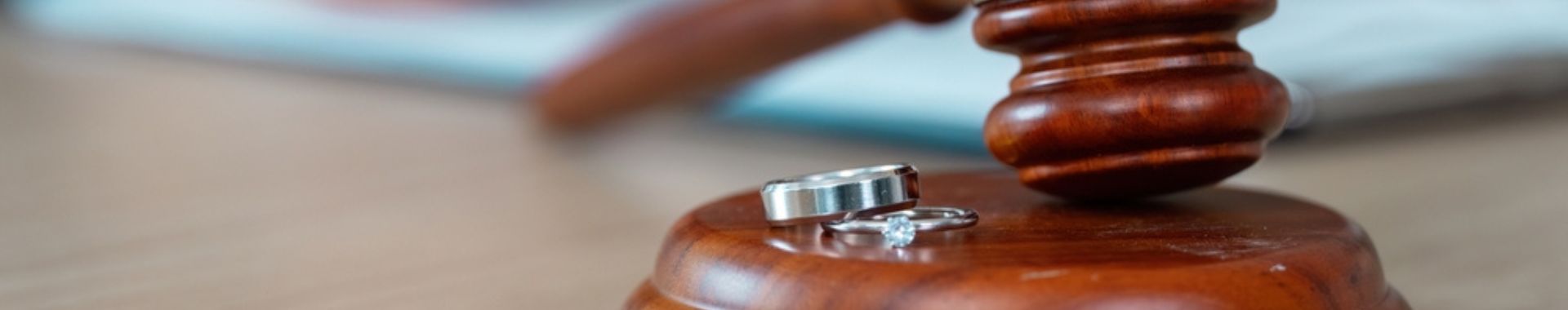 divorce proceedings with wedding rings and a court gavel