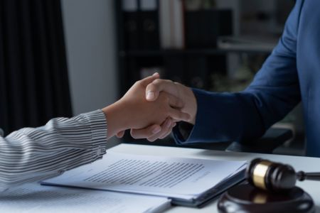 A lawyer shaking hands with a client
